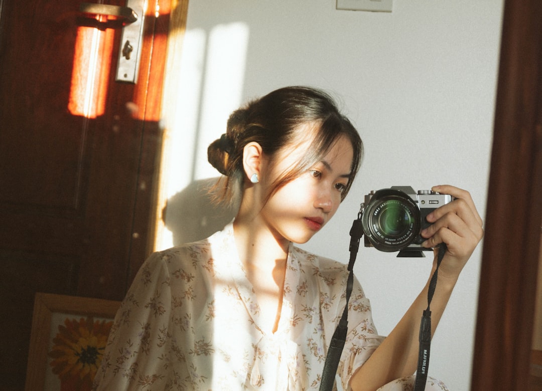 a woman taking a picture of herself in a mirror,