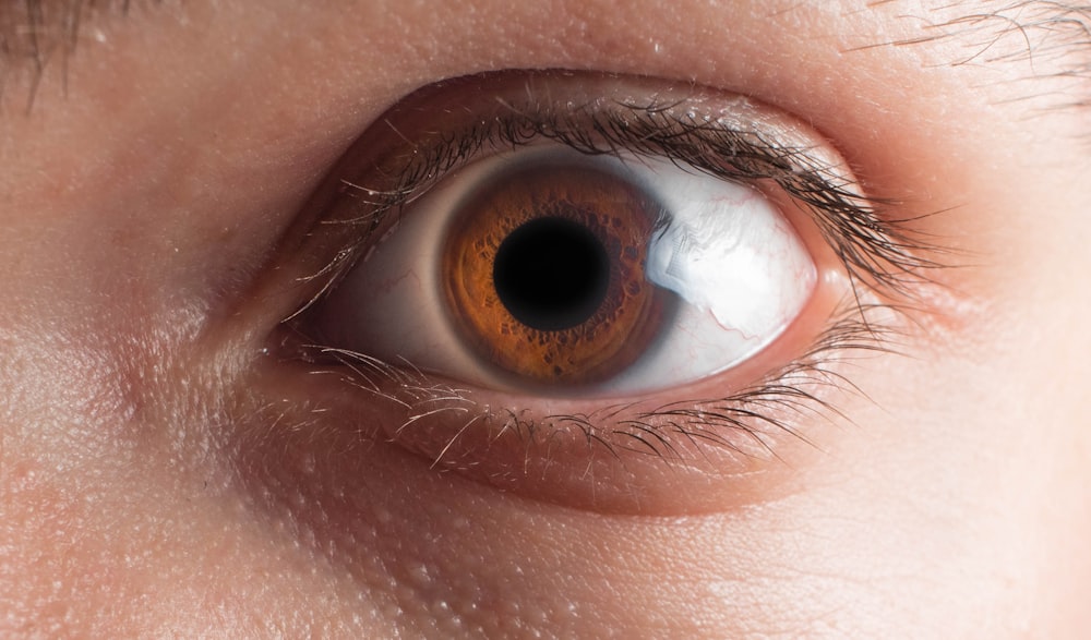 a close up of a person's brown eye