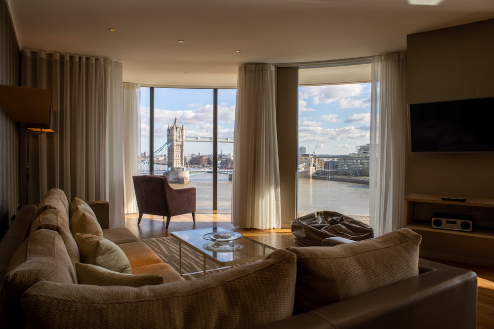 a living room filled with furniture and a large window