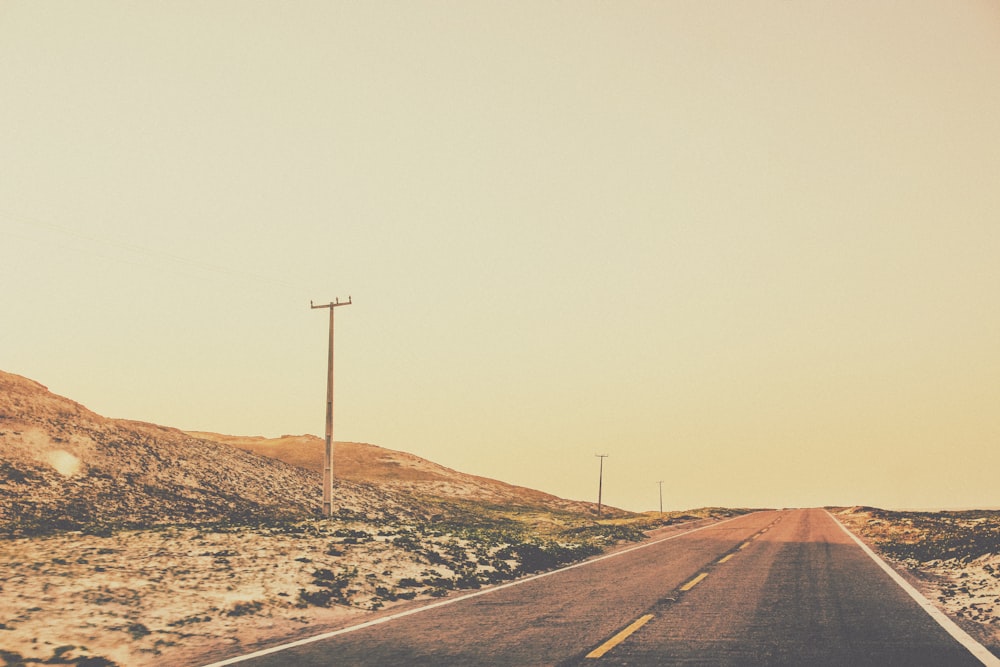 an empty road in the middle of a desert