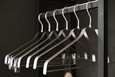 a bunch of clothes hangers in a closet