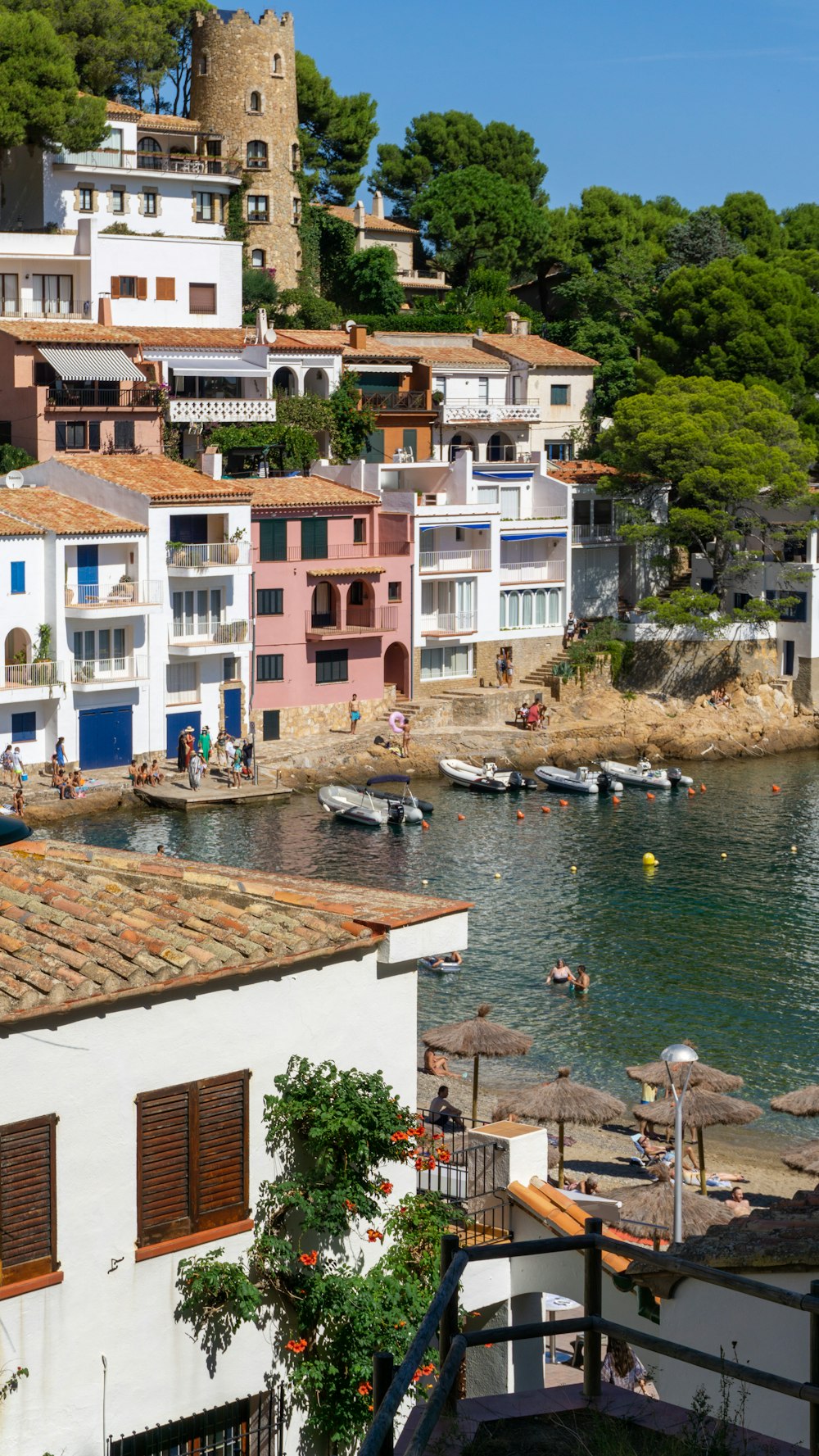 a group of buildings on the shore of a body of water