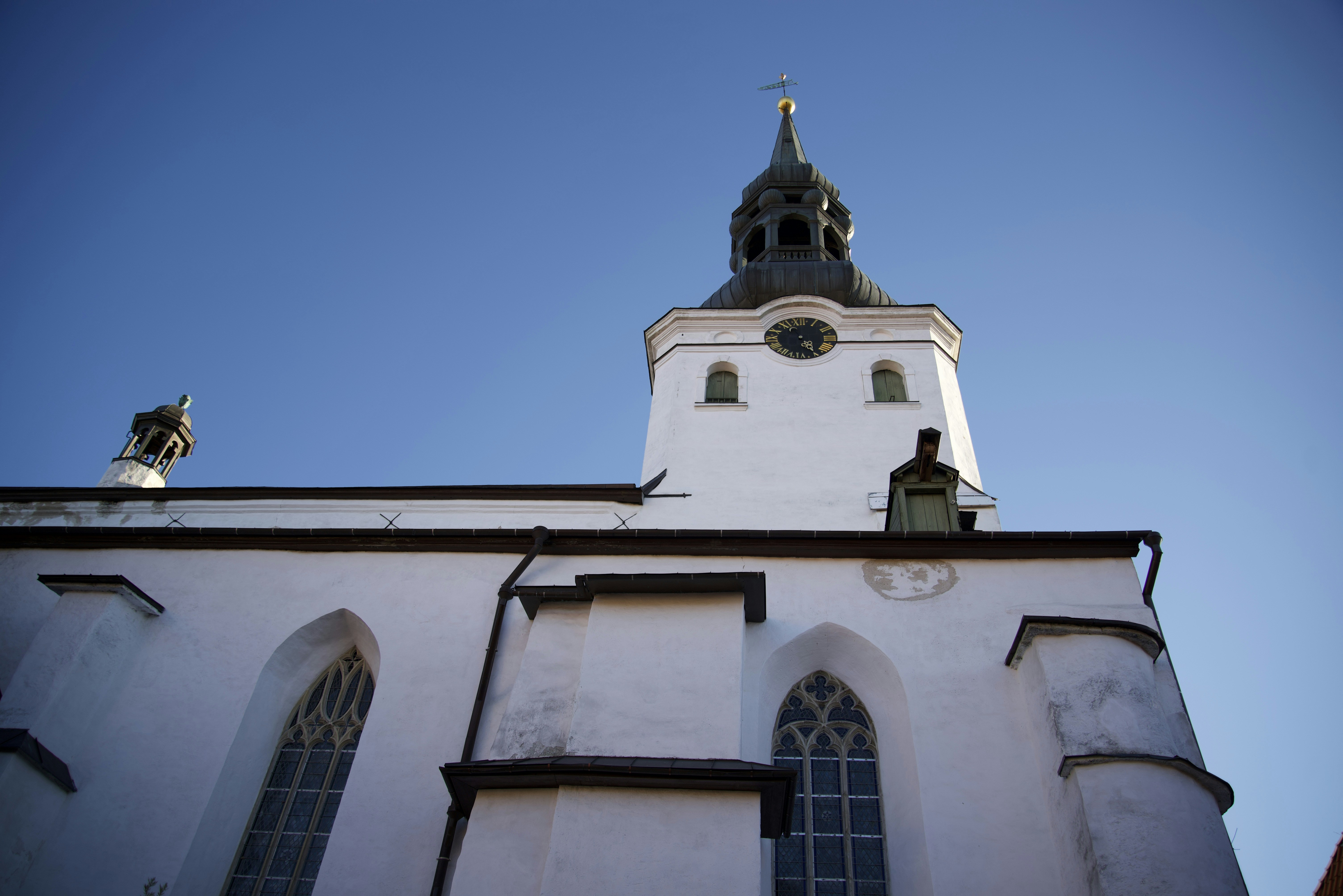 a tall white building with a clock on it