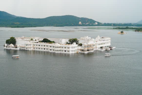 a large white building sitting on top of a lake
