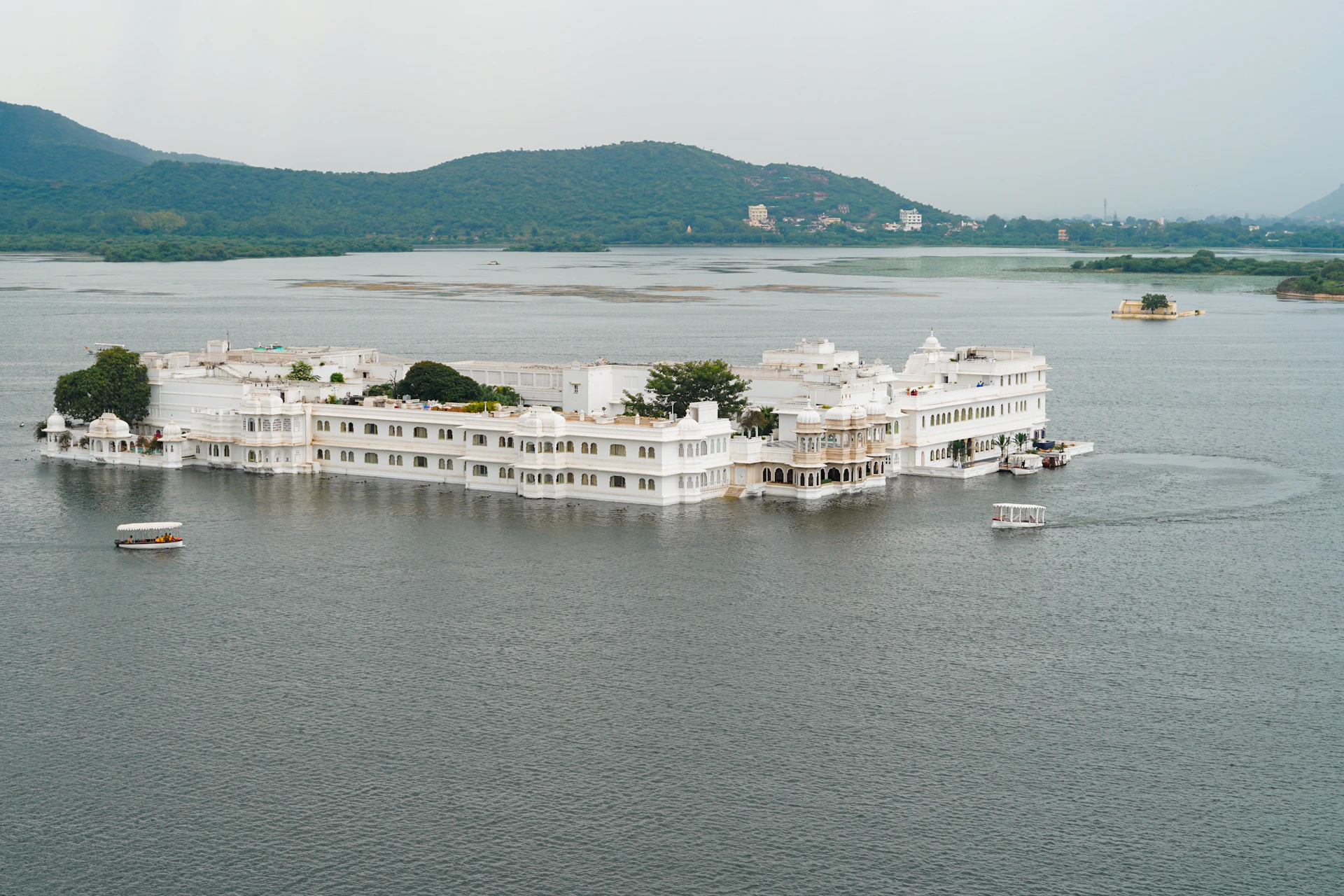 a large white building sitting on top of a lake