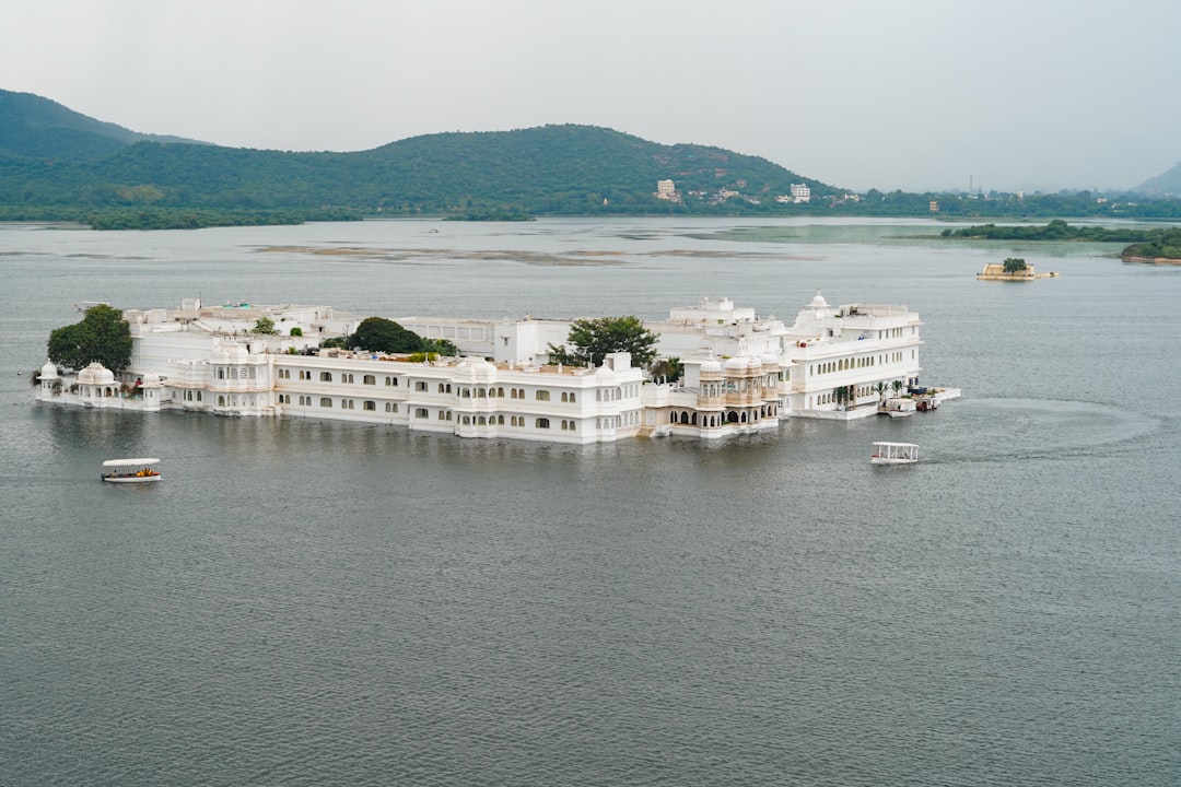 a large white building sitting on top of a lake,