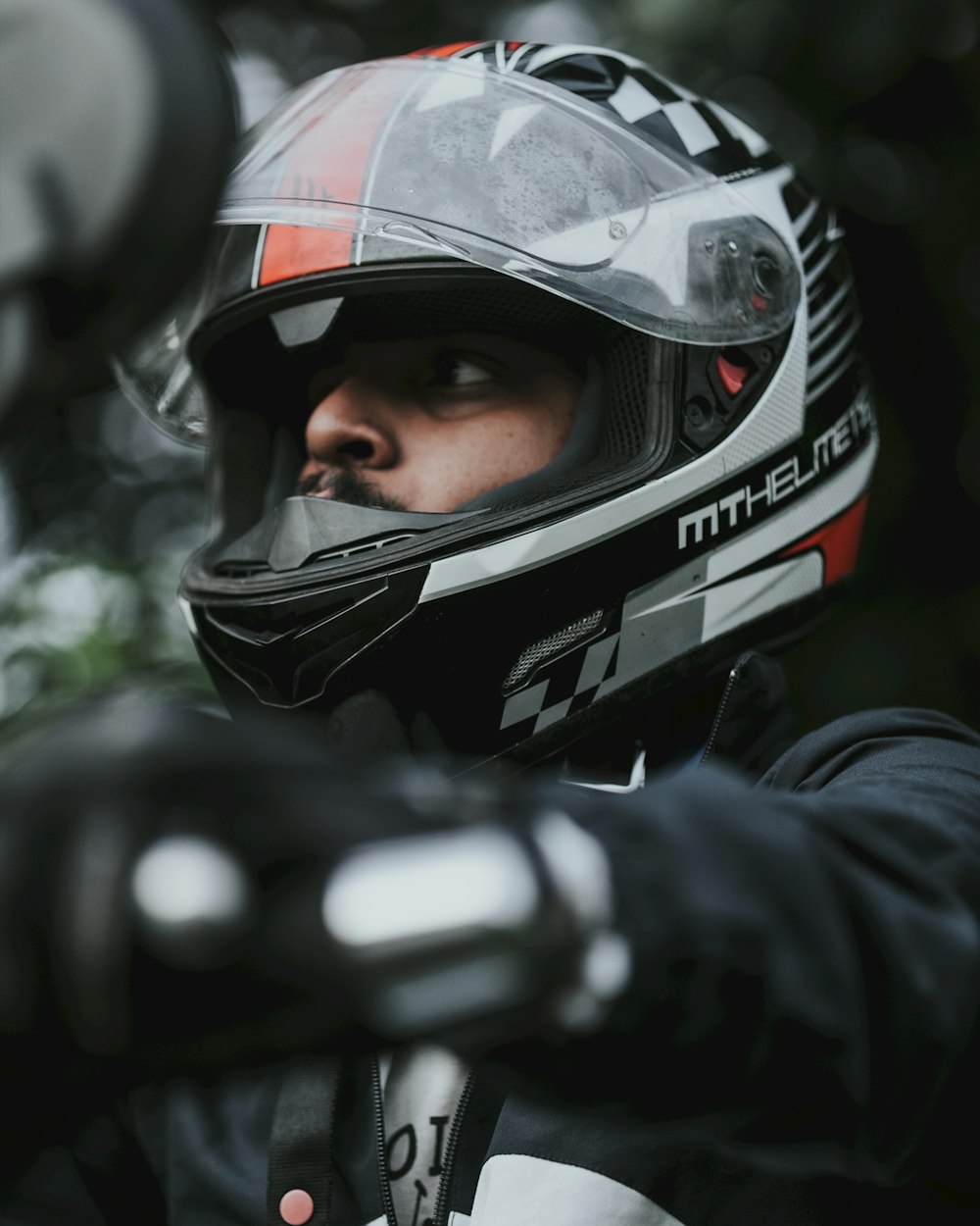 a man wearing a helmet and holding a motorcycle bike