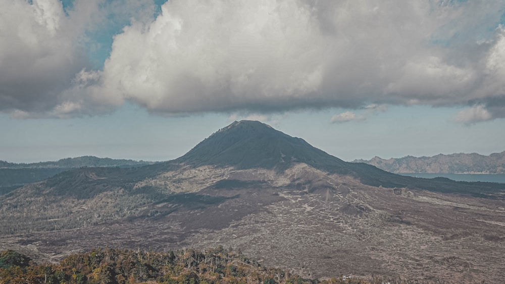 a view of a mountain with clouds in the sky