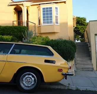 a yellow car parked in front of a house
