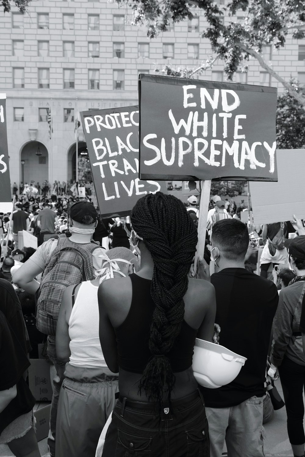 a group of people holding signs in front of a building