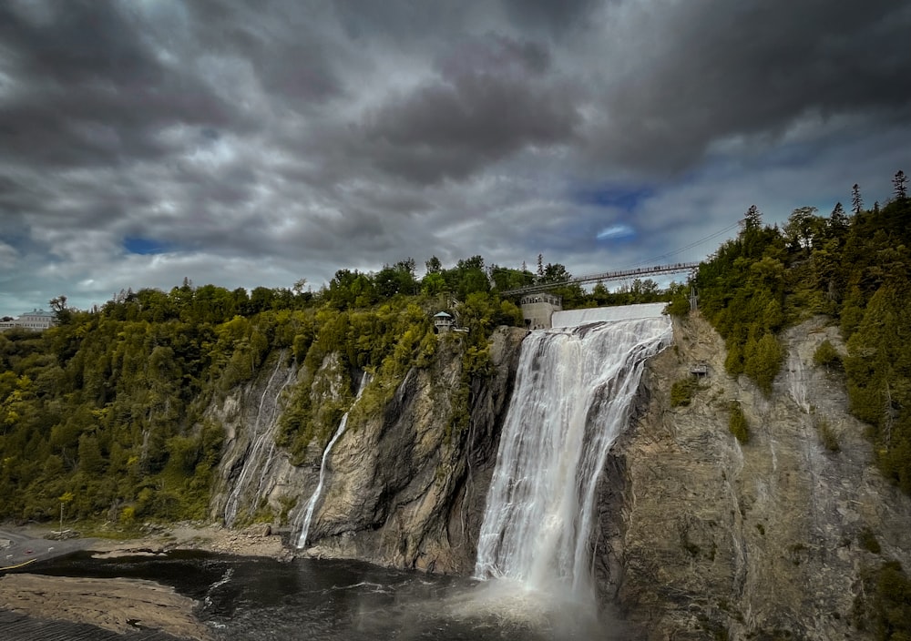 a waterfall with a house on top of it