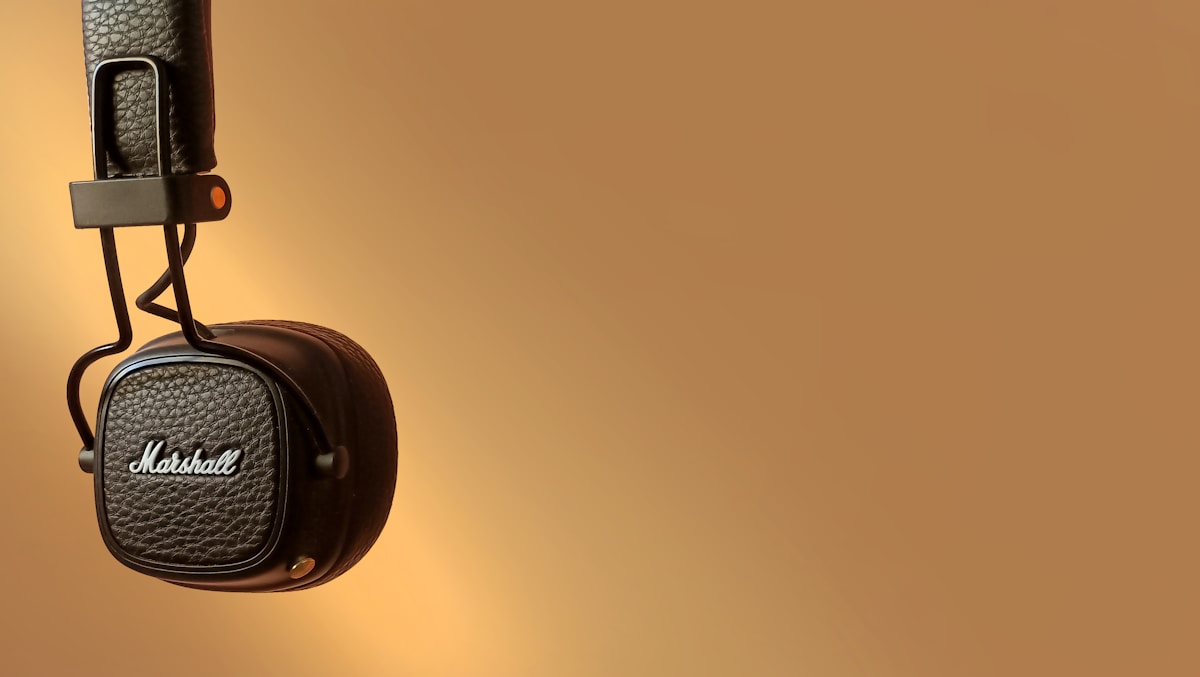 A pair of headphones hanging from a hook