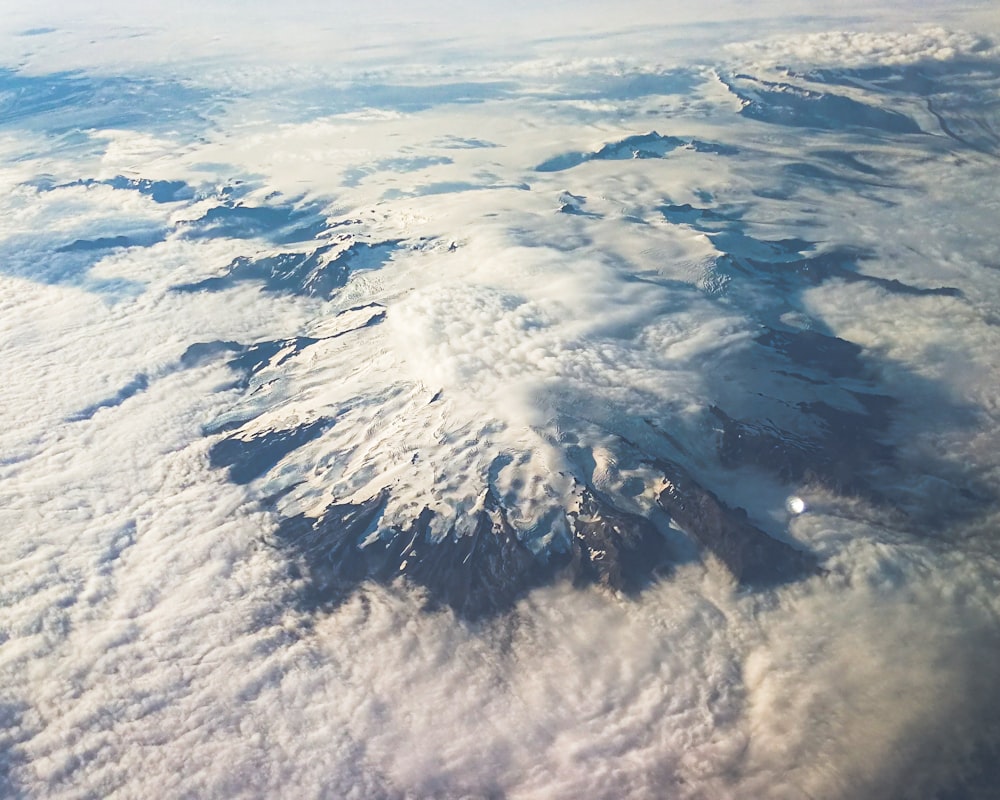 a view of a snow covered mountain from an airplane