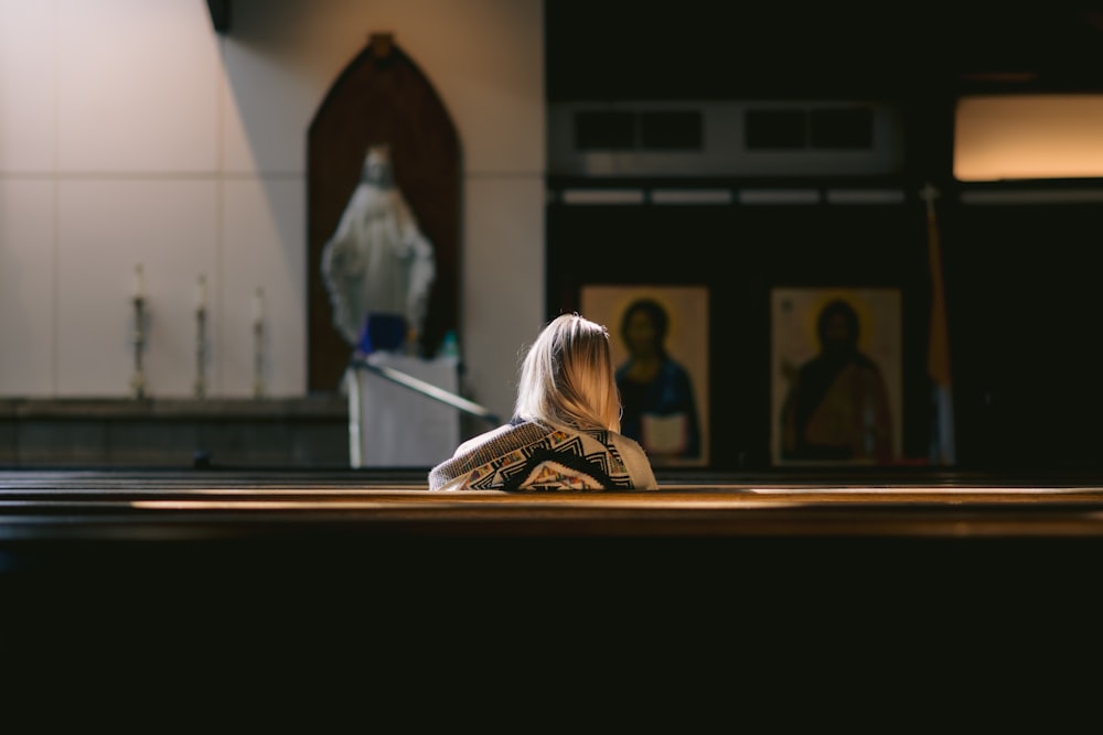 a woman sitting on the floor in a church