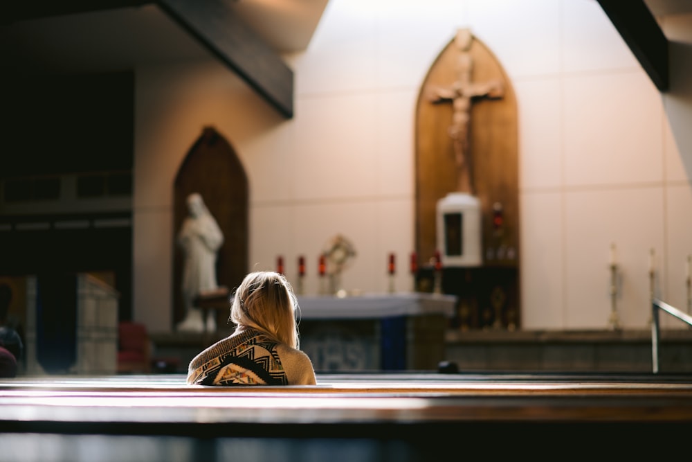 a woman sitting on the floor of a church