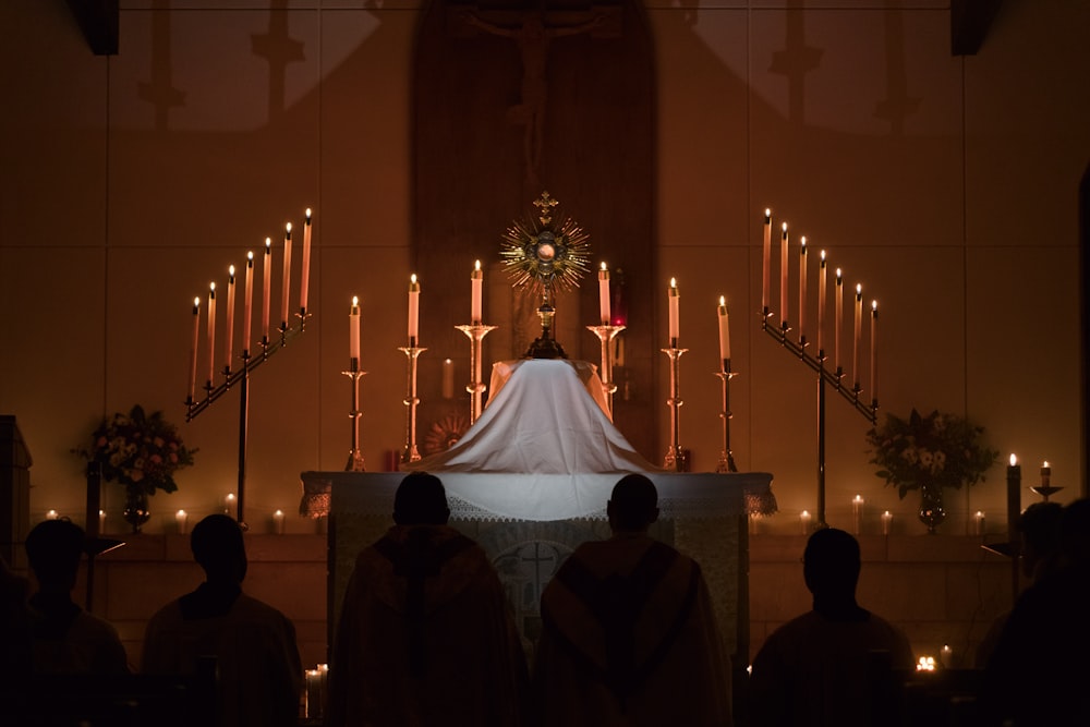 a group of people standing around a church altar