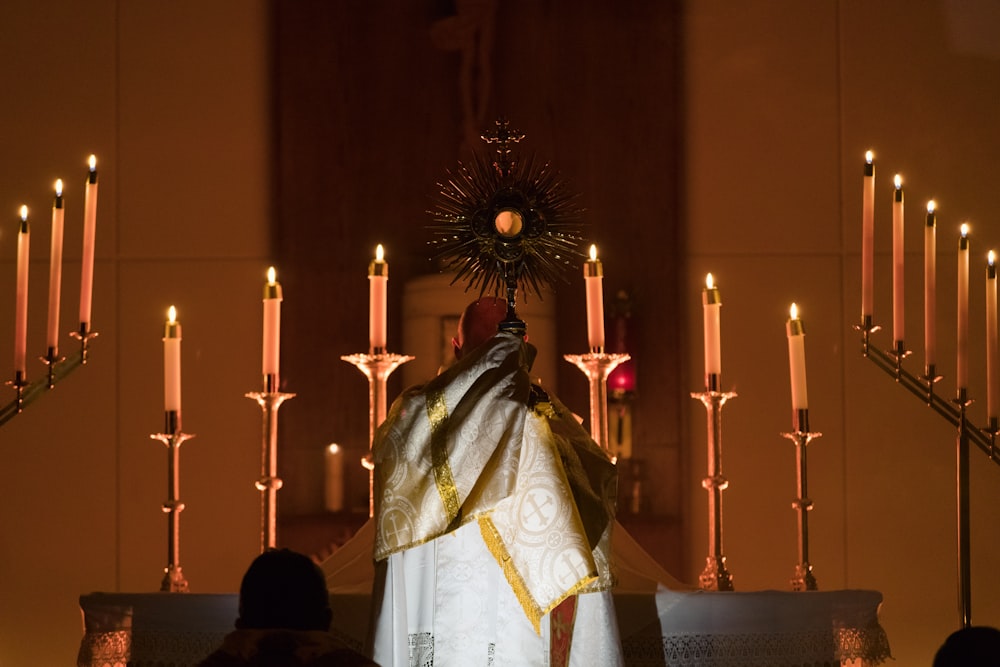 a priest standing at the alter of a church