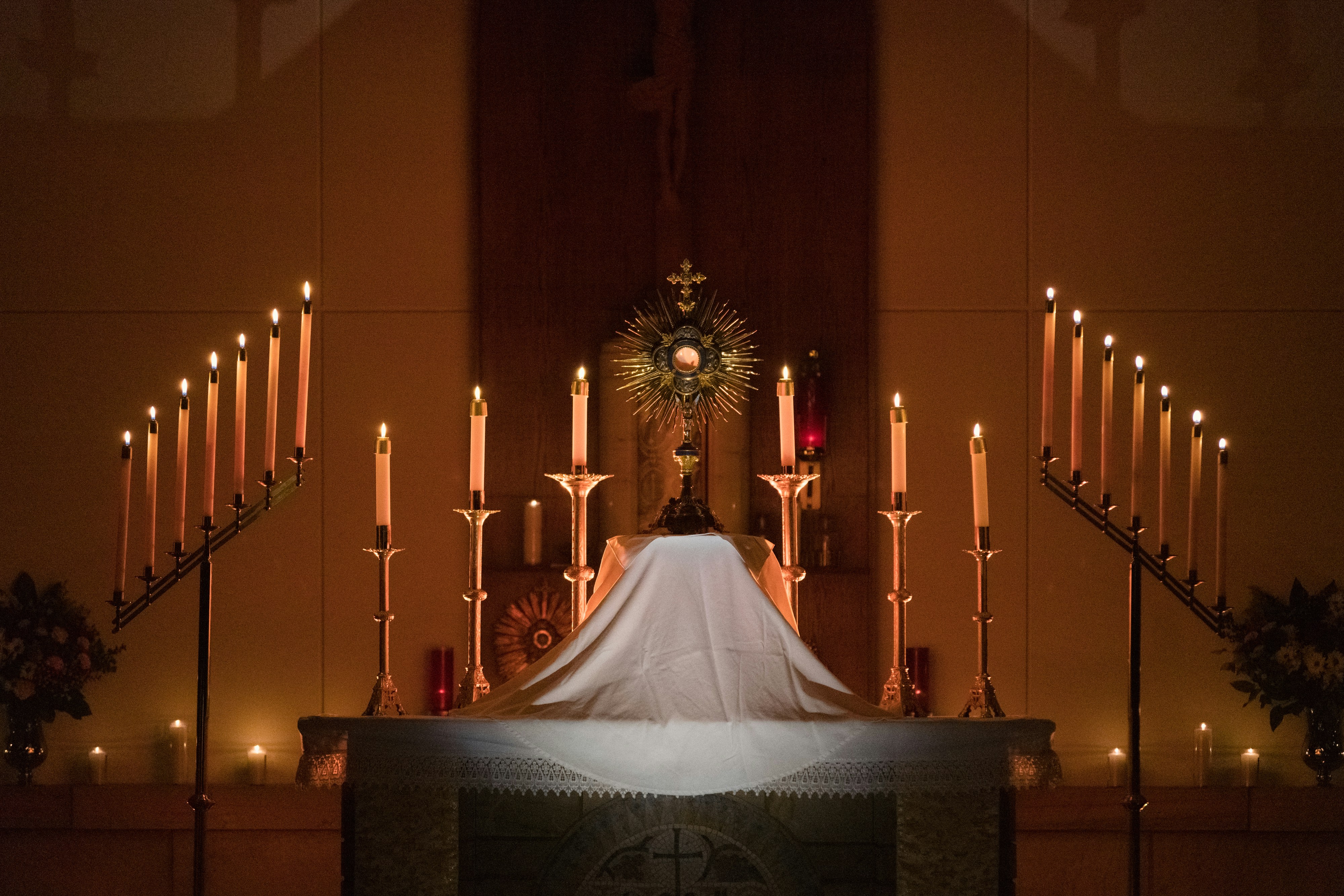 a bride and groom standing at the alter of a church