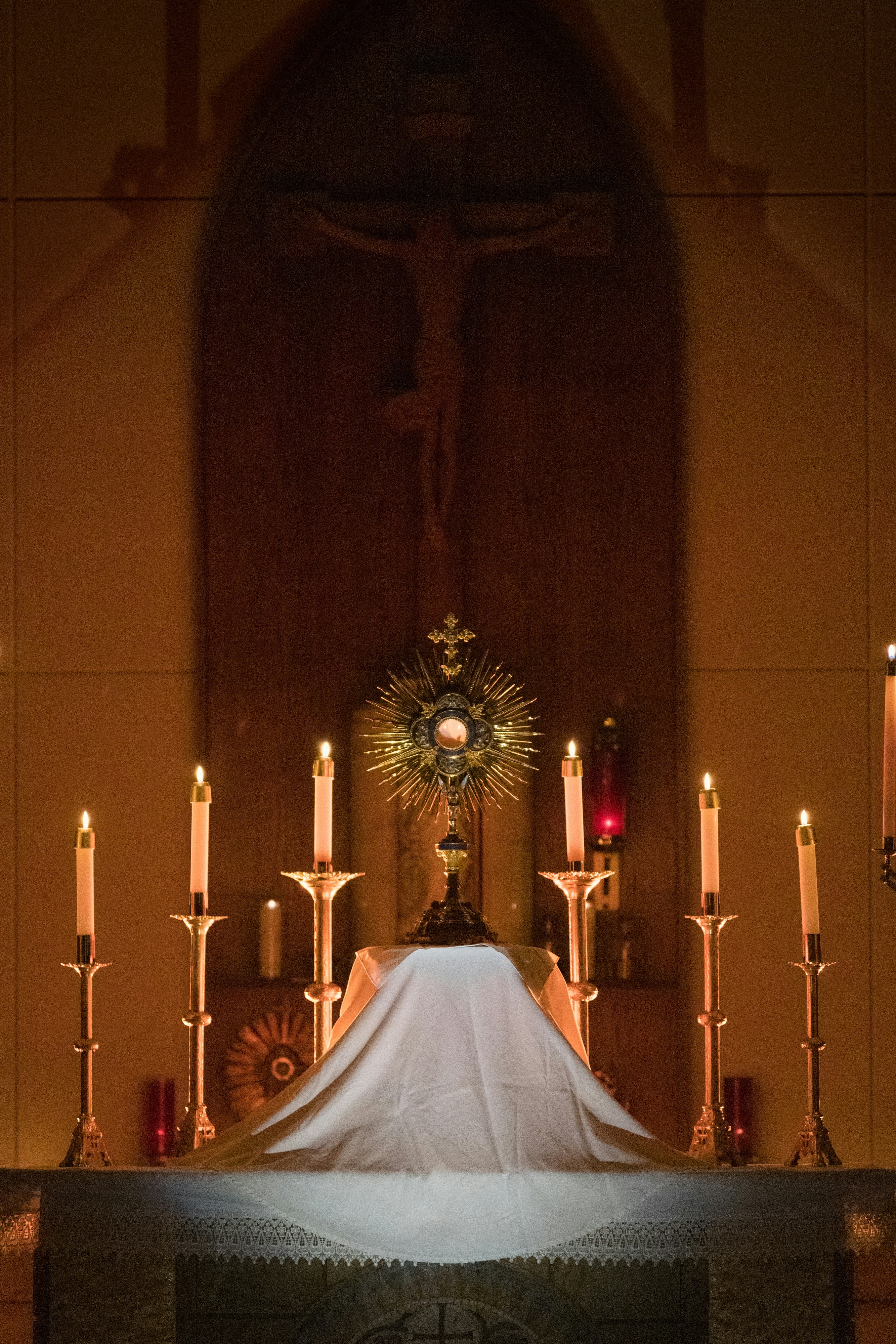 a church alter with a white cloth draped over it