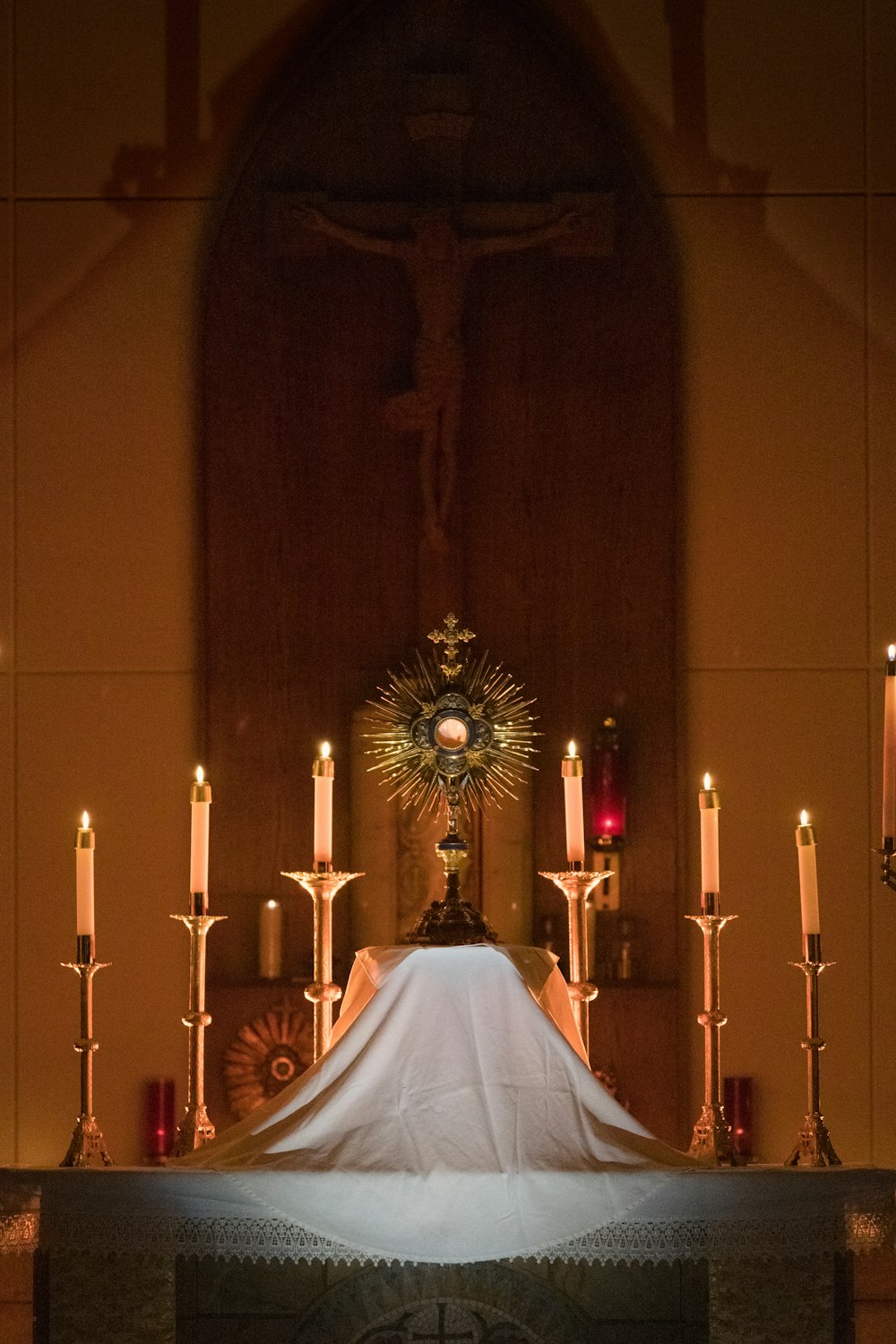 a church alter with a white cloth draped over it