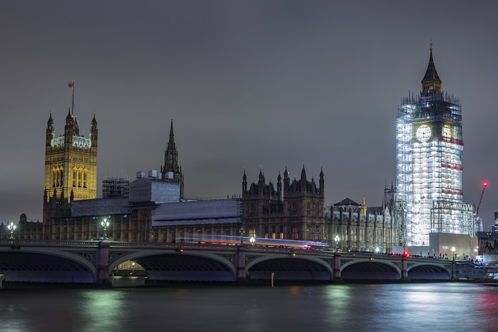 a large clock tower towering over a city at night