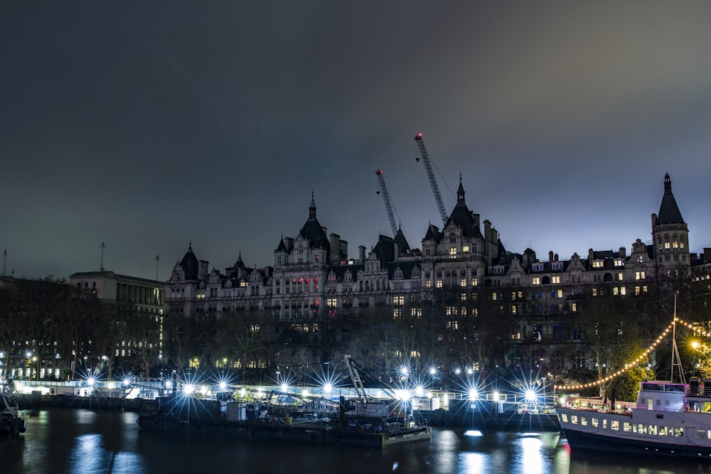 a boat is docked in a harbor at night