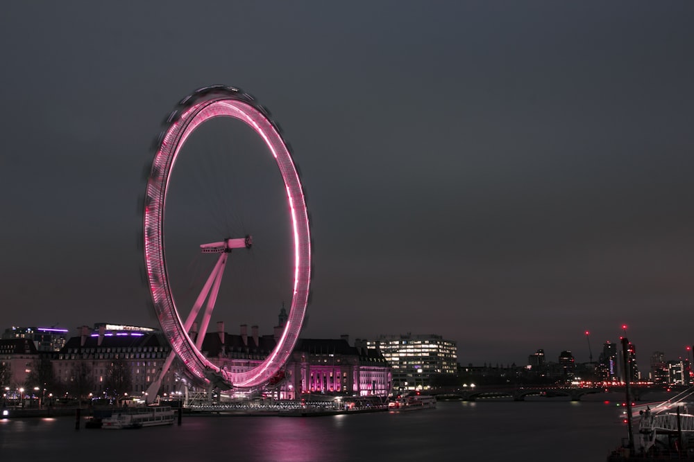 a ferris wheel lit up in the night sky