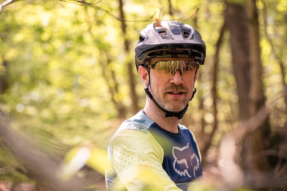 a man riding a bike through a forest