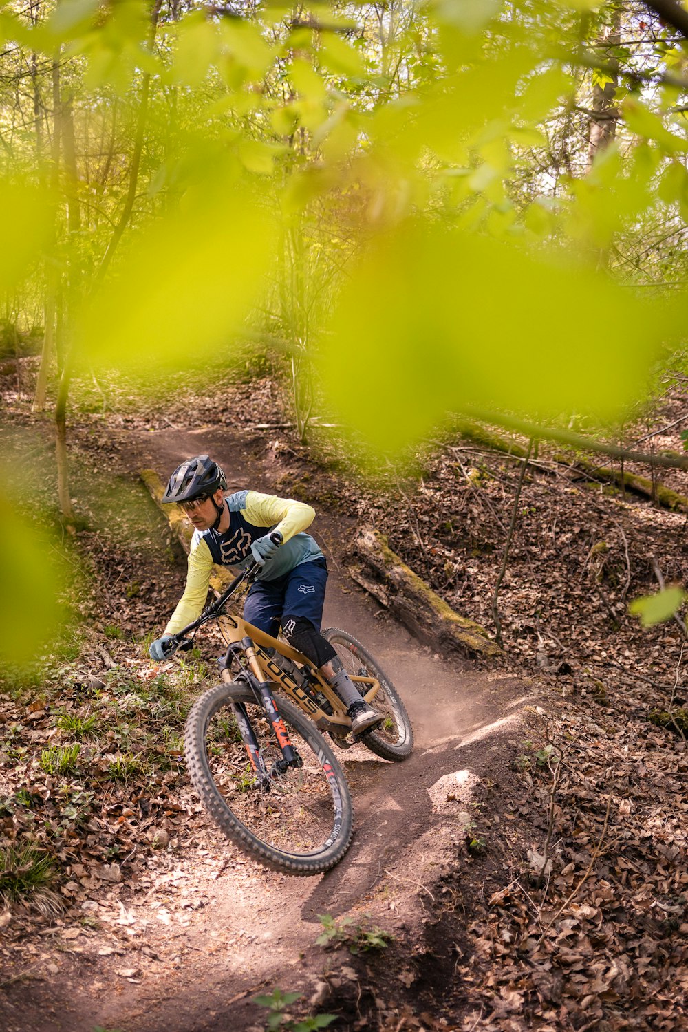 a man riding a bike down a dirt trail