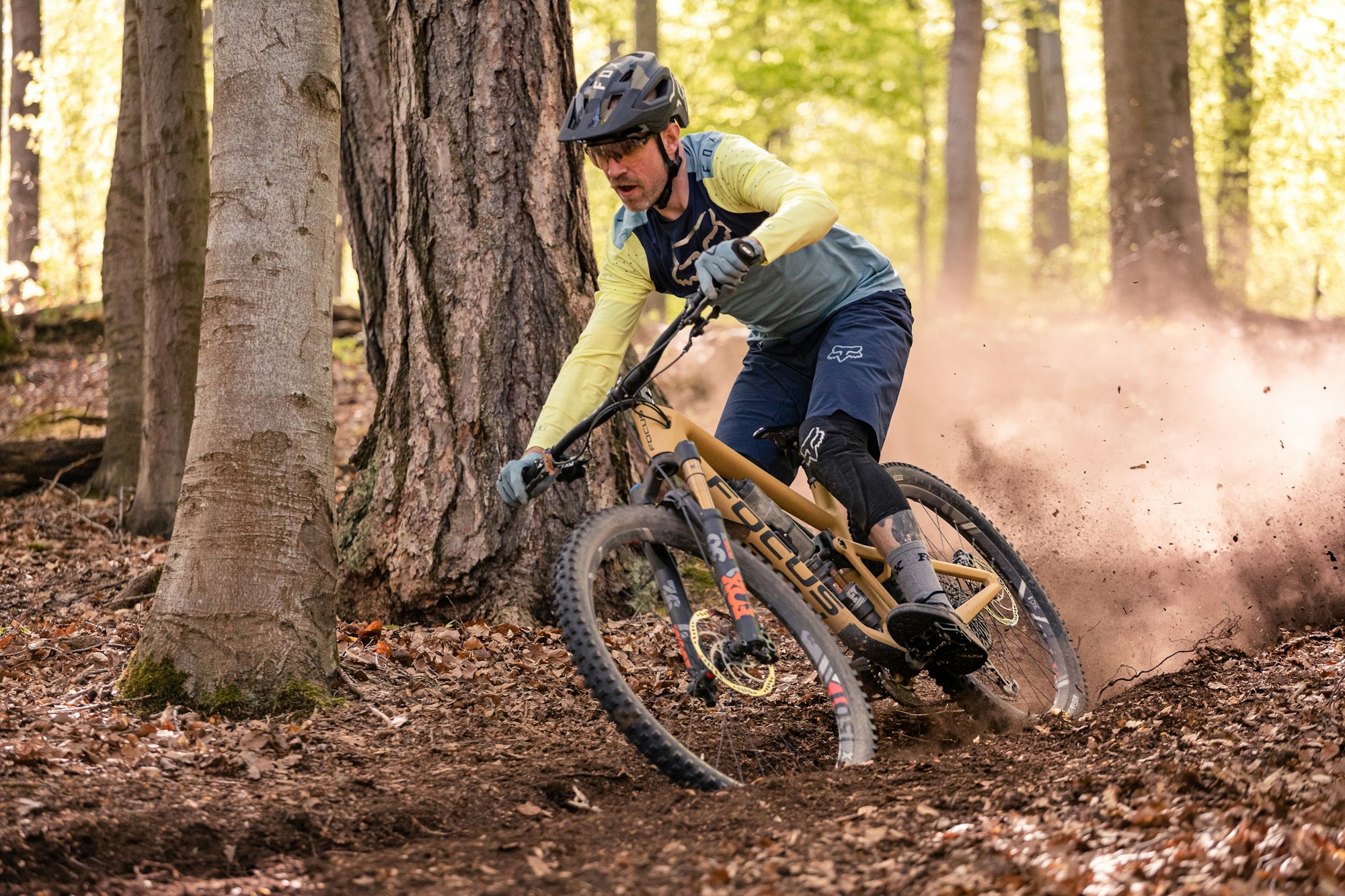 Stuttgart area, Baden-Württemberg, Germany: A male mountain biker on a Focus mountain bike ripping a dusty turn in the forest on a sunny spring day.
