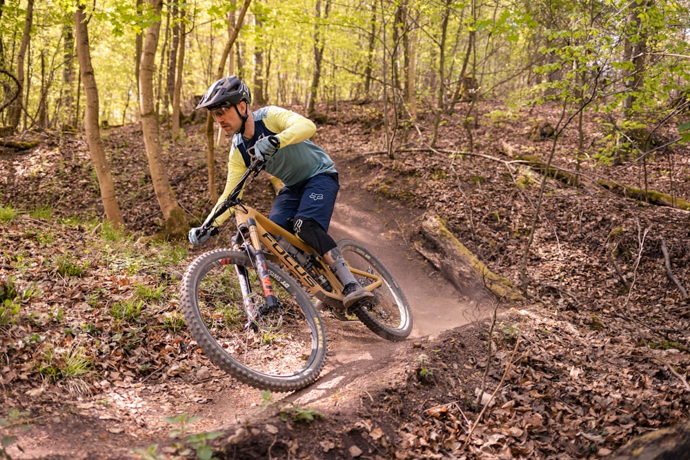 a man riding a bike down a dirt trail