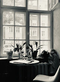 a black and white photo of a table and a chair