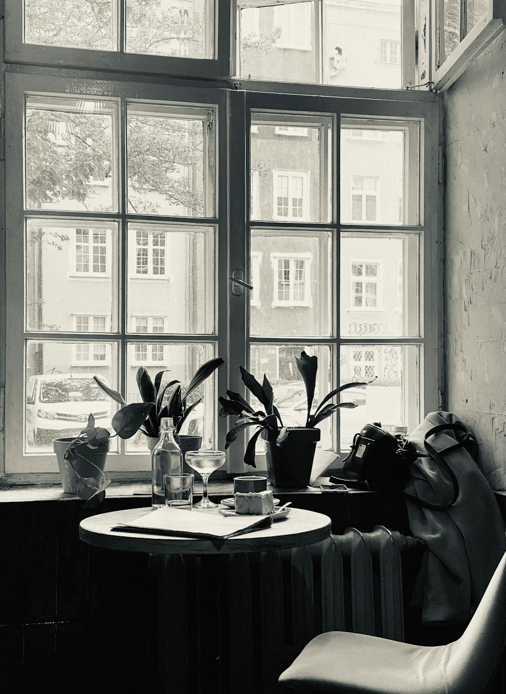 a black and white photo of a table and a chair