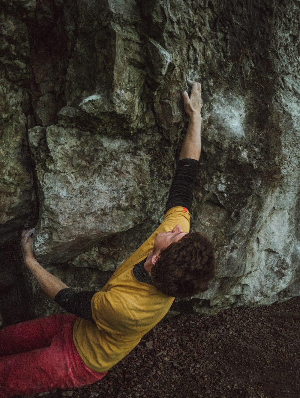 a man climbing up the side of a mountain