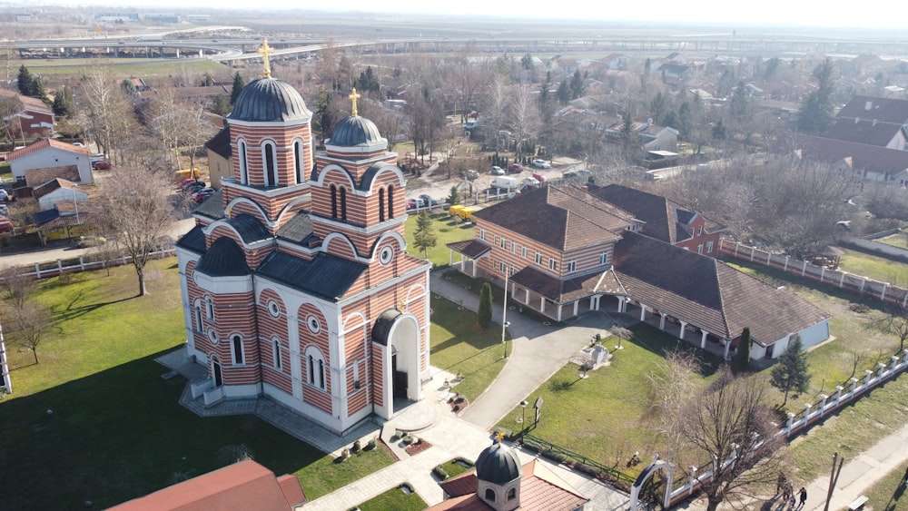 an aerial view of a church in a small town