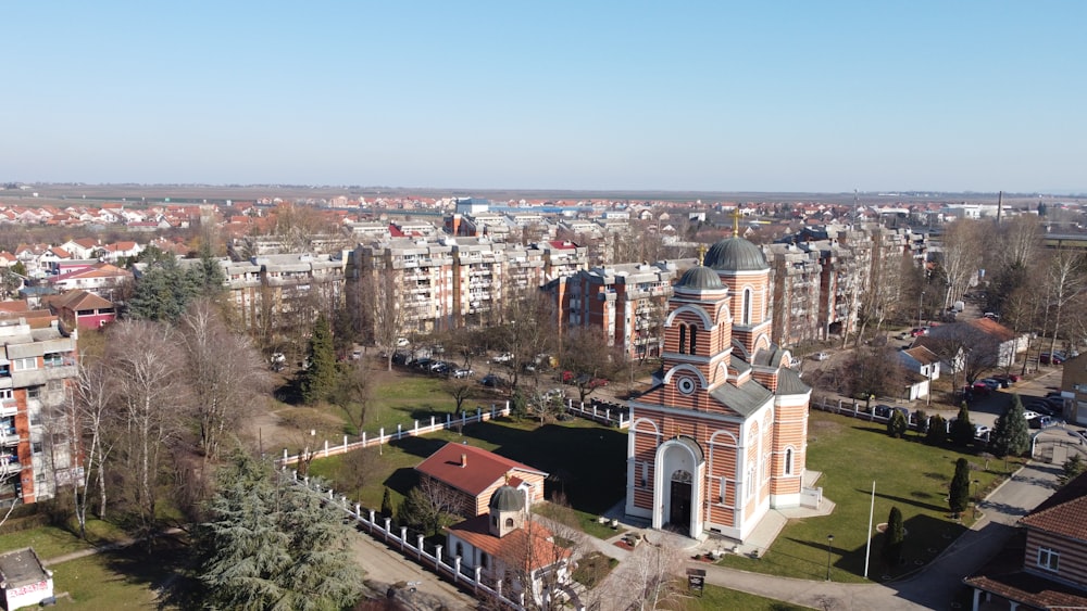 an aerial view of a city with a church in the center