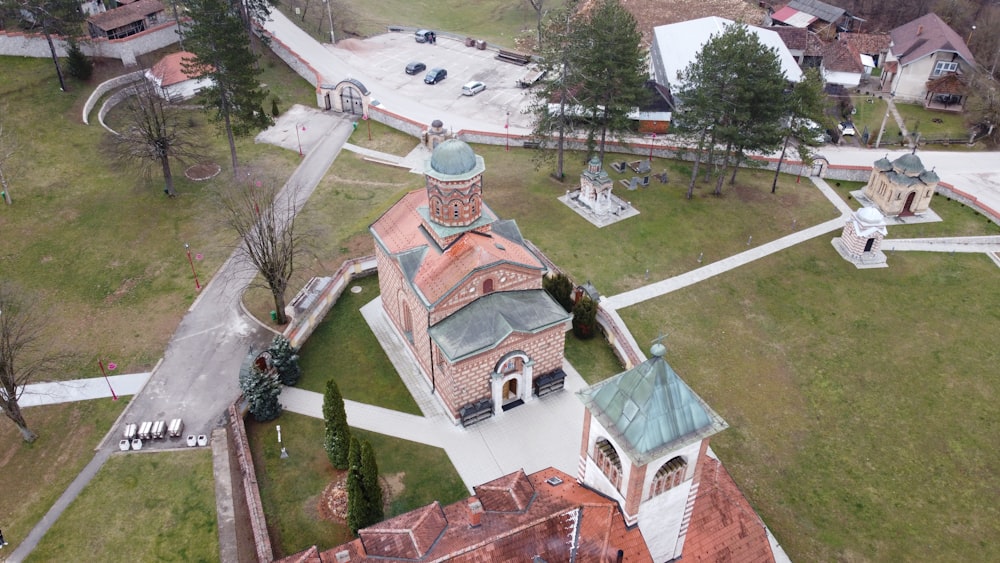 an aerial view of a church in the middle of a park