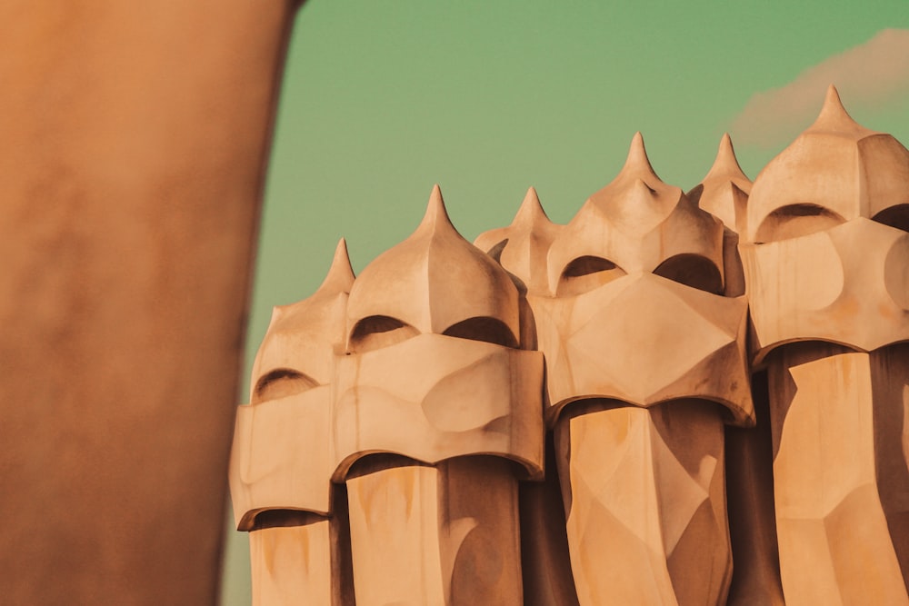 a close up of a wooden sculpture with a sky background