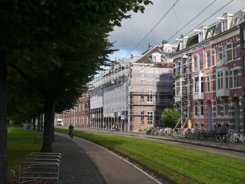 a row of brick buildings next to a green field