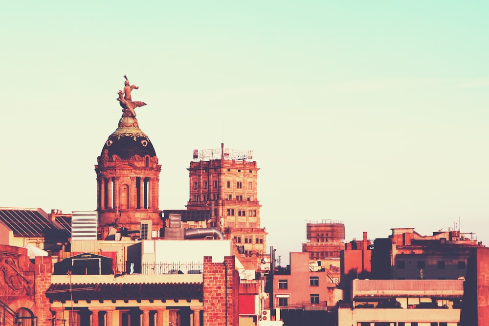 a view of a city with a statue on top of a building