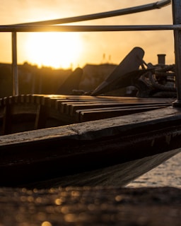 Sunset view of a boat anchored near a quiet cove, ready for an evening tour.
