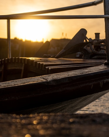 Sunset view of a boat anchored near a quiet cove, ready for an evening tour.