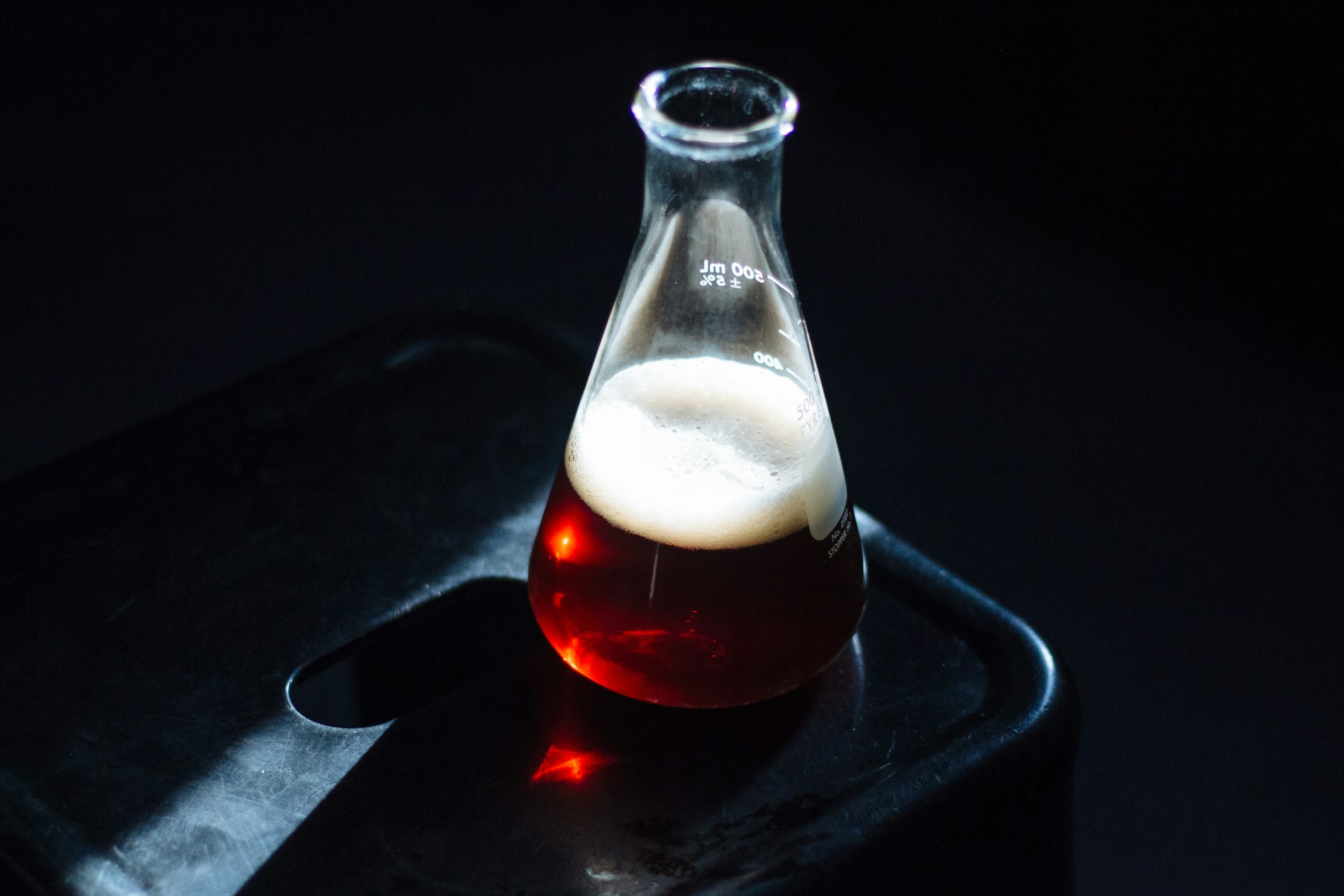 a glass filled with liquid sitting on top of a table