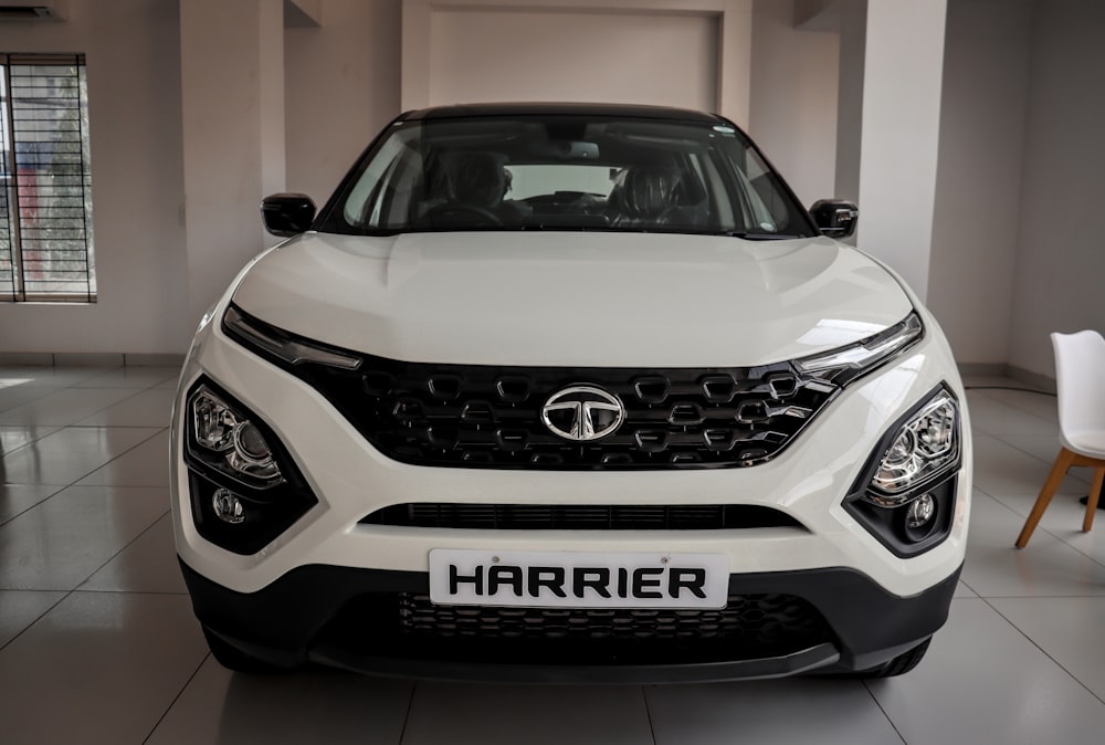 the front of a white car in a showroom