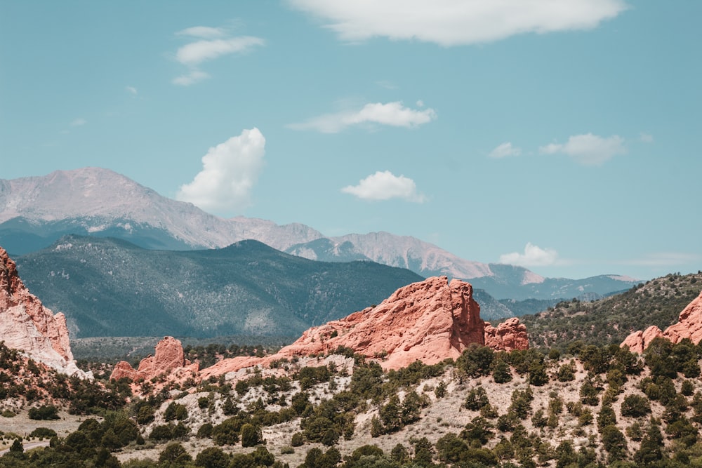 a mountain range with trees and mountains in the background