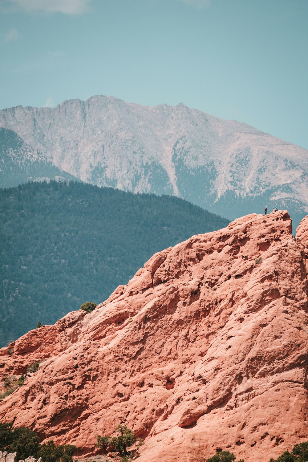 a person standing on top of a large rock