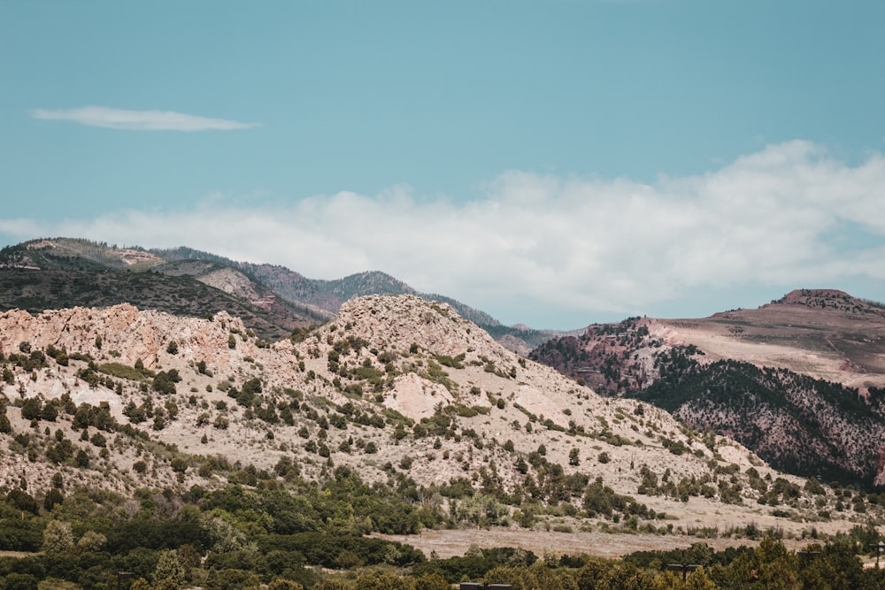 a view of a mountain range with trees and mountains in the background