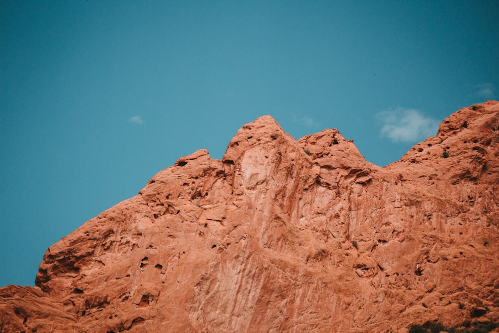 a red rock formation with a blue sky in the background