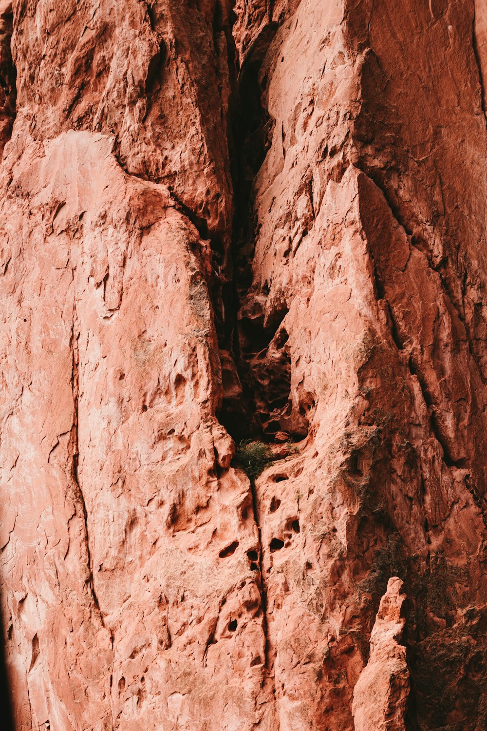 a person climbing up the side of a mountain