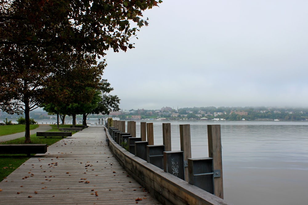 a long wooden dock next to a body of water